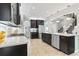 A modern kitchen with stainless steel appliances, dark wood cabinets, and quartz countertops at 1416 Castleberry Pl., Myrtle Beach, SC 29588