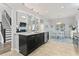 Bright, open kitchen with island, stainless steel appliances, and adjacent breakfast nook and living room at 1416 Castleberry Pl., Myrtle Beach, SC 29588