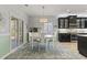 Eat-in kitchen with black cabinets, a white table, and sliding doors to the deck at 1416 Castleberry Pl., Myrtle Beach, SC 29588