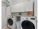 Laundry room featuring a modern washer and dryer set and white cabinets for storage at 1416 Castleberry Pl., Myrtle Beach, SC 29588