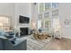 Bright and airy living room with a fireplace, tall windows, and comfortable seating at 1416 Castleberry Pl., Myrtle Beach, SC 29588