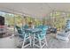 Relaxing screened-in patio features stylish furniture, fan, and views of lush landscaping at 1416 Castleberry Pl., Myrtle Beach, SC 29588
