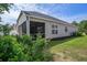 Spacious backyard featuring a screened-in porch and lush greenery at 1434 Chanson Ct., Little River, SC 29566