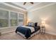 Bedroom featuring a tray ceiling, carpeted floor, large window and a bed with a blue quilt at 1434 Chanson Ct., Little River, SC 29566