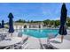 Sparkling community pool with tables, chairs, and umbrellas for a relaxing day at 1434 Chanson Ct., Little River, SC 29566