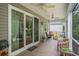 Inviting covered patio with ceiling fans, comfortable seating, and outdoor views at 1434 Chanson Ct., Little River, SC 29566