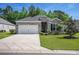 Charming brick home featuring an attached garage and a well-manicured lawn at 1434 Chanson Ct., Little River, SC 29566
