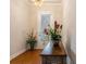 Close-up of foyer with hardwood floors, front door with blinds, and decorative plants at 1434 Chanson Ct., Little River, SC 29566