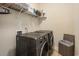 Efficient laundry room with modern washer and dryer, shelving, and storage basket at 1434 Chanson Ct., Little River, SC 29566
