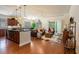 Inviting open-concept living room with a kitchen island, hardwood floors, and sliding glass doors at 1434 Chanson Ct., Little River, SC 29566