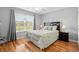 Bedroom with large window letting in lots of natural light and beautiful wood flooring at 1536 Abberbury Dr., Conway, SC 29527