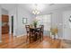Dining area with hardwood floors, modern chandelier, vaulted ceilings, and view into the kitchen at 1536 Abberbury Dr., Conway, SC 29527