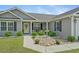 Charming home with a vibrant rock garden, complemented by a yellow door and black shutters at 1536 Abberbury Dr., Conway, SC 29527