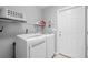 Well-lit laundry room equipped with modern washer and dryer units and ample shelving at 1536 Abberbury Dr., Conway, SC 29527