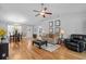 Open-concept living room with hardwood floors, ceiling fan, vaulted ceilings, and a dining area at 1536 Abberbury Dr., Conway, SC 29527
