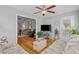 Cozy living room with hardwood floors, comfortable couches, and a view into another room with a TV and seating at 1536 Abberbury Dr., Conway, SC 29527