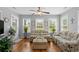 Inviting sunroom featuring comfortable seating, hardwood flooring, and an abundance of natural light through multiple windows at 1536 Abberbury Dr., Conway, SC 29527