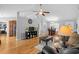 Bright living room featuring hardwood floors, ceiling fan, leather ottoman, and gray walls at 1536 Abberbury Dr., Conway, SC 29527