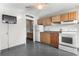 Compact kitchen featuring tile flooring, white appliances, and wooden cabinets at 1600 S Ocean Blvd. # 254, Myrtle Beach, SC 29577