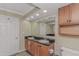 Well-lit bathroom includes double sinks with granite countertops, cabinets, and a large mirror at 1625 S Ocean Blvd. # 1210, North Myrtle Beach, SC 29582