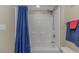 Clean bathroom with a shower and blue curtain, complemented by neutral wall colors at 1625 S Ocean Blvd. # 1210, North Myrtle Beach, SC 29582