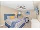 This stylish bedroom includes two queen beds, a ceiling fan, and ocean-themed artwork at 1625 S Ocean Blvd. # 1210, North Myrtle Beach, SC 29582