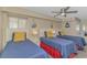 Bright bedroom featuring three twin beds with stylish nautical themed decor and ceiling fan at 1625 S Ocean Blvd. # 1210, North Myrtle Beach, SC 29582