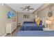 Comfortable bedroom showcases three beds, a modern dresser, and stylish, vibrant artwork at 1625 S Ocean Blvd. # 1210, North Myrtle Beach, SC 29582