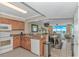 Open concept kitchen with stainless sink, wood cabinets, and granite countertops providing ample space for cooking at 1625 S Ocean Blvd. # 1210, North Myrtle Beach, SC 29582