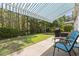 Relaxing covered back patio with seating and views of the green landscaped yard and wooded area at 1681 Suncrest Dr., Myrtle Beach, SC 29577