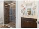 Bathroom with a tiled glass-enclosed shower and single sink vanity with cabinet at 1681 Suncrest Dr., Myrtle Beach, SC 29577
