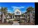 Clubhouse exterior featuring well-manicured landscaping and inviting lounge areas at 1681 Suncrest Dr., Myrtle Beach, SC 29577