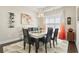 Bright dining room with modern light fixture and a glass top table for six at 1681 Suncrest Dr., Myrtle Beach, SC 29577