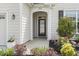 Inviting front porch with decorative glass door, stylish lighting and landscaped garden at 1681 Suncrest Dr., Myrtle Beach, SC 29577