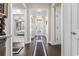 Welcoming hallway with elegant chandelier, dark floors, and decorative light-colored walls at 1681 Suncrest Dr., Myrtle Beach, SC 29577