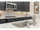This kitchen features granite counters, a stylish backsplash, and stainless steel appliances at 1681 Suncrest Dr., Myrtle Beach, SC 29577