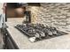 Close up on the gourmet gas range and granite counters, highlighting the kitchen's amenities at 1681 Suncrest Dr., Myrtle Beach, SC 29577