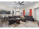 Open living room featuring dark wood floors, a large sectional, and an open view to the kitchen at 1681 Suncrest Dr., Myrtle Beach, SC 29577