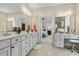 Main bathroom with dual vanities, white cabinets, and a separate makeup area at 1681 Suncrest Dr., Myrtle Beach, SC 29577