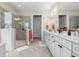 Main bathroom featuring a glass enclosed shower, dual vanities, and neutral tile at 1681 Suncrest Dr., Myrtle Beach, SC 29577