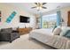 Spacious main bedroom with a large window, a ceiling fan, and a comfortable seating area at 1681 Suncrest Dr., Myrtle Beach, SC 29577