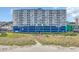 Exterior view of condo complex with beach access, parking garage, and well-maintained landscaping at 1709 S Ocean Blvd. # 403, North Myrtle Beach, SC 29582