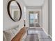 Inviting hallway with a decorative mirror leading to an ocean view balcony at 1709 S Ocean Blvd. # 403, North Myrtle Beach, SC 29582
