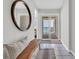 Inviting hallway with a stylish bench and a view of the ocean from the sliding glass doors at 1709 S Ocean Blvd. # 403, North Myrtle Beach, SC 29582