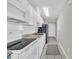 Efficient condo kitchen with white cabinets, subway tile backsplash, and updated appliances at 1709 S Ocean Blvd. # 403, North Myrtle Beach, SC 29582