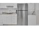 Well-equipped kitchen featuring stainless steel refrigerator and stackable washer/dryer at 1709 S Ocean Blvd. # 403, North Myrtle Beach, SC 29582