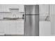 Condo kitchen featuring stainless steel refrigerator, granite countertops, and stackable washer/dryer at 1709 S Ocean Blvd. # 403, North Myrtle Beach, SC 29582