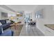 Open concept living and dining area with tile flooring, blue sofas, and ocean views at 1709 S Ocean Blvd. # 403, North Myrtle Beach, SC 29582