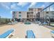 Outdoor pool and lounge area with beach chairs and ocean views at 1709 S Ocean Blvd. # 403, North Myrtle Beach, SC 29582