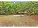 Private backyard with sand basketball court area shaded by trees at 1729 Longleaf Dr., Myrtle Beach, SC 29575